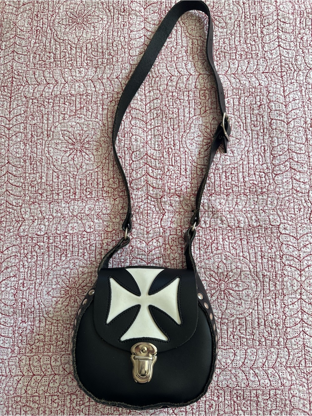Like new Genuine Black Leather Crossbody Bag with White Cross Accent.
